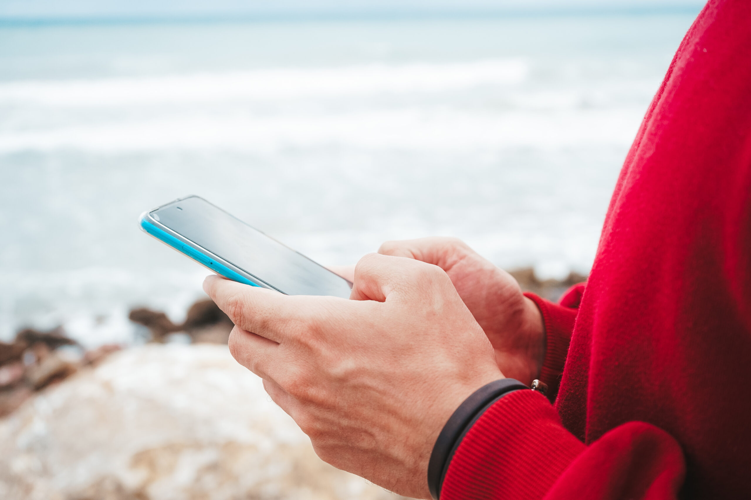 Hands holding a new smart phone